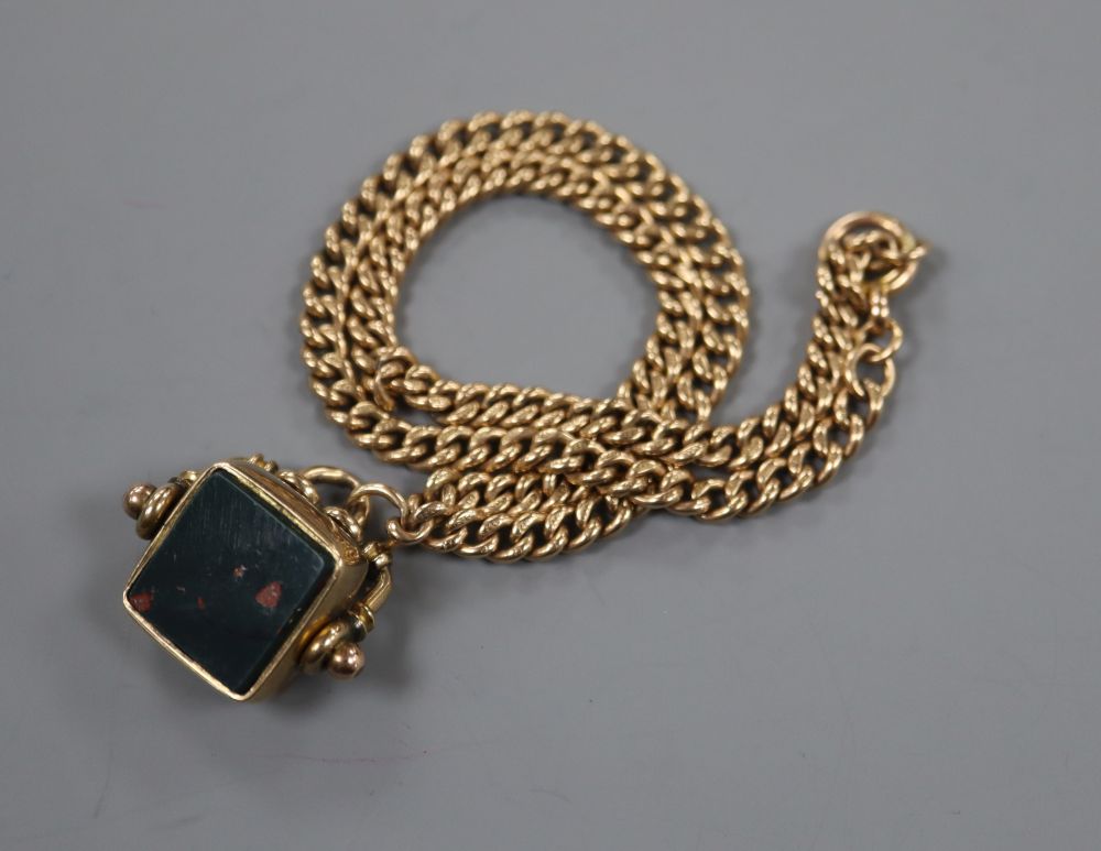 A late Victoria 9ct gold curblink chain, 38cm, hung with a 9ct gold, bloodstone and carnelian set spinning fob, gross 31.4 grams.